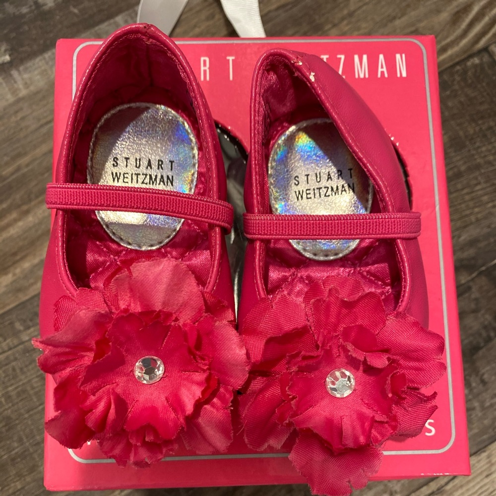 Hot pink baby shoes .